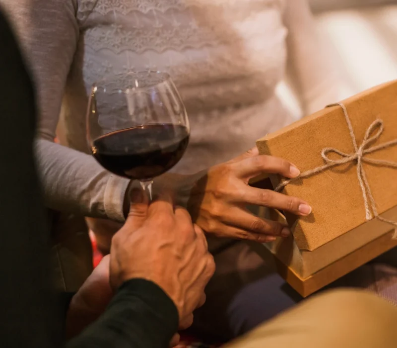 melvino-wines-couple-opening-gifts-together-with-glass-wine